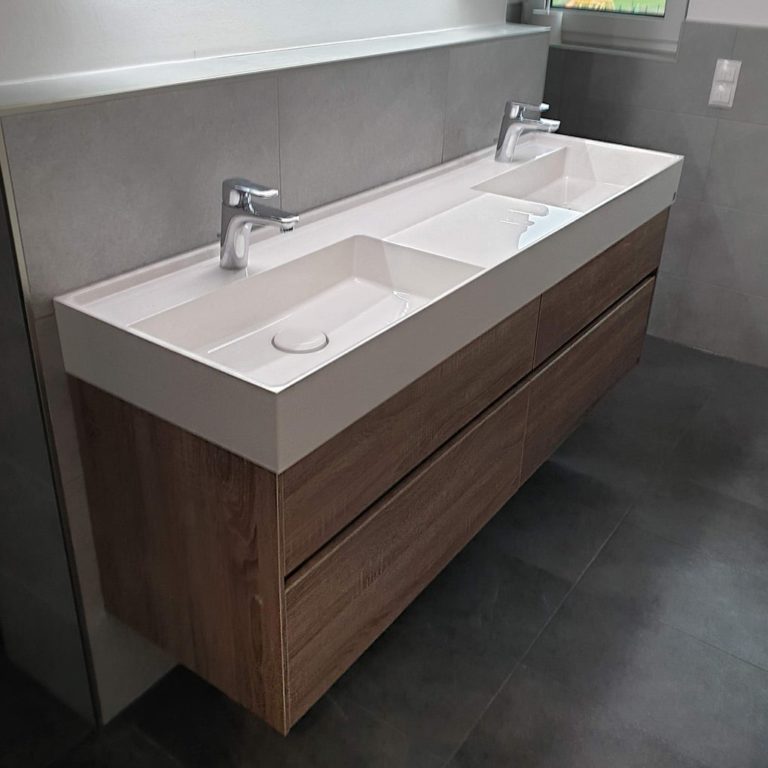 a double sink on a wooden base cabinet bathroom assembly