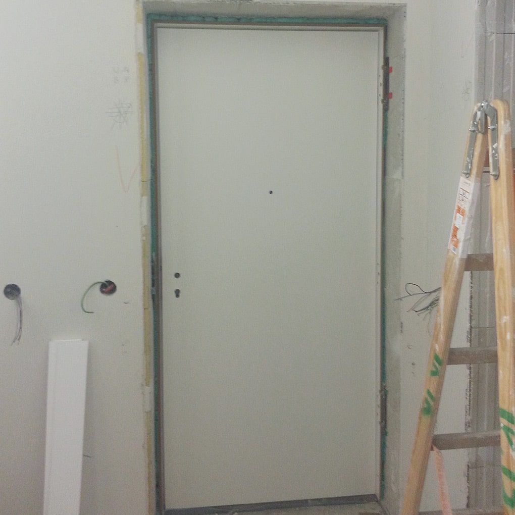 an assembled apartment door in a building shell