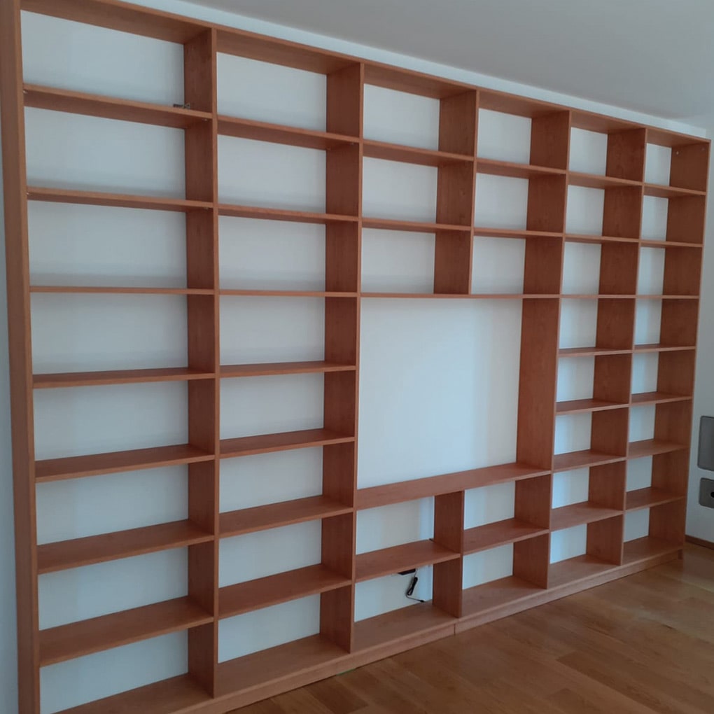 large wall shelf system with TV recess in the middle
