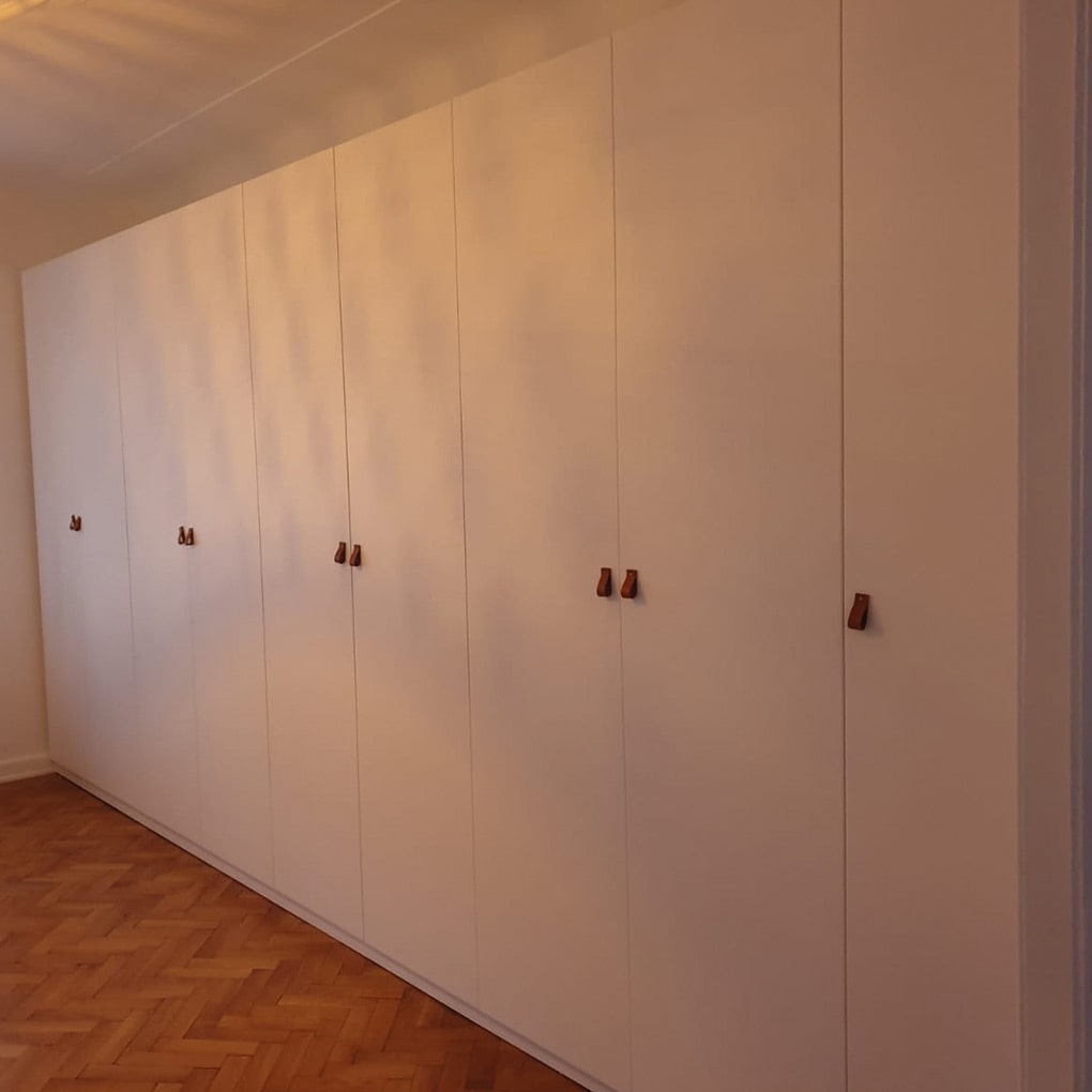 large closet in white with many doors