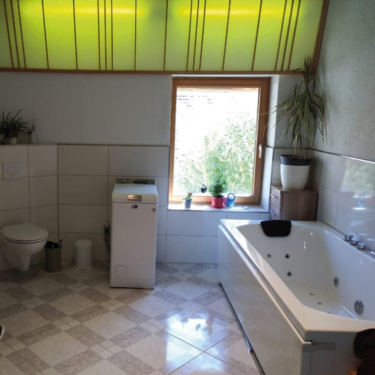 a fully tiled and installed bathroom with bathtub