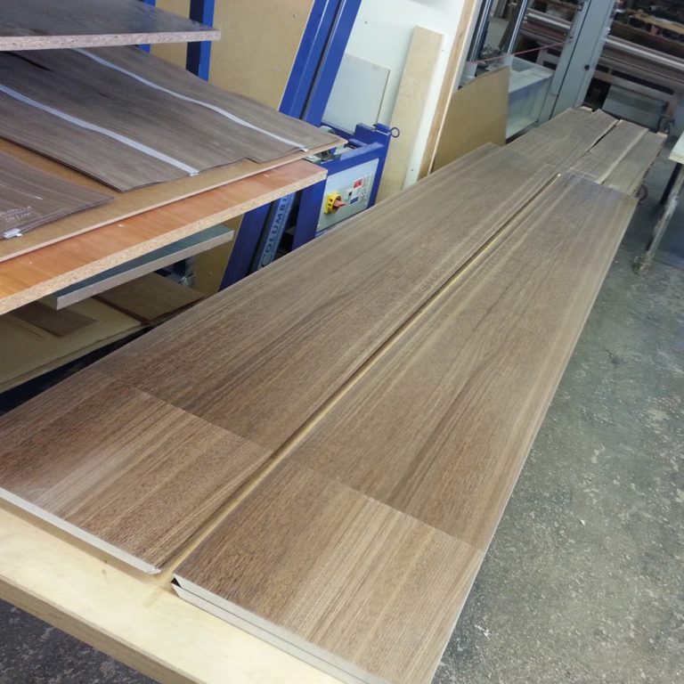 two long wall panels on a workbench