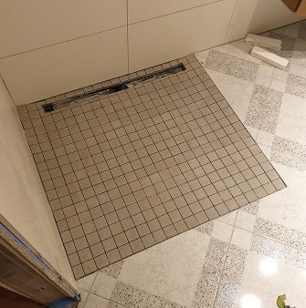 installed bathroom tiles after water damage