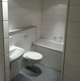 a tiled bathroom with light tiles