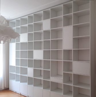 a large white shelving system with especially many open and some closed units