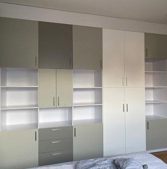 A mounted modern wall cabinet in white, gray and olive green